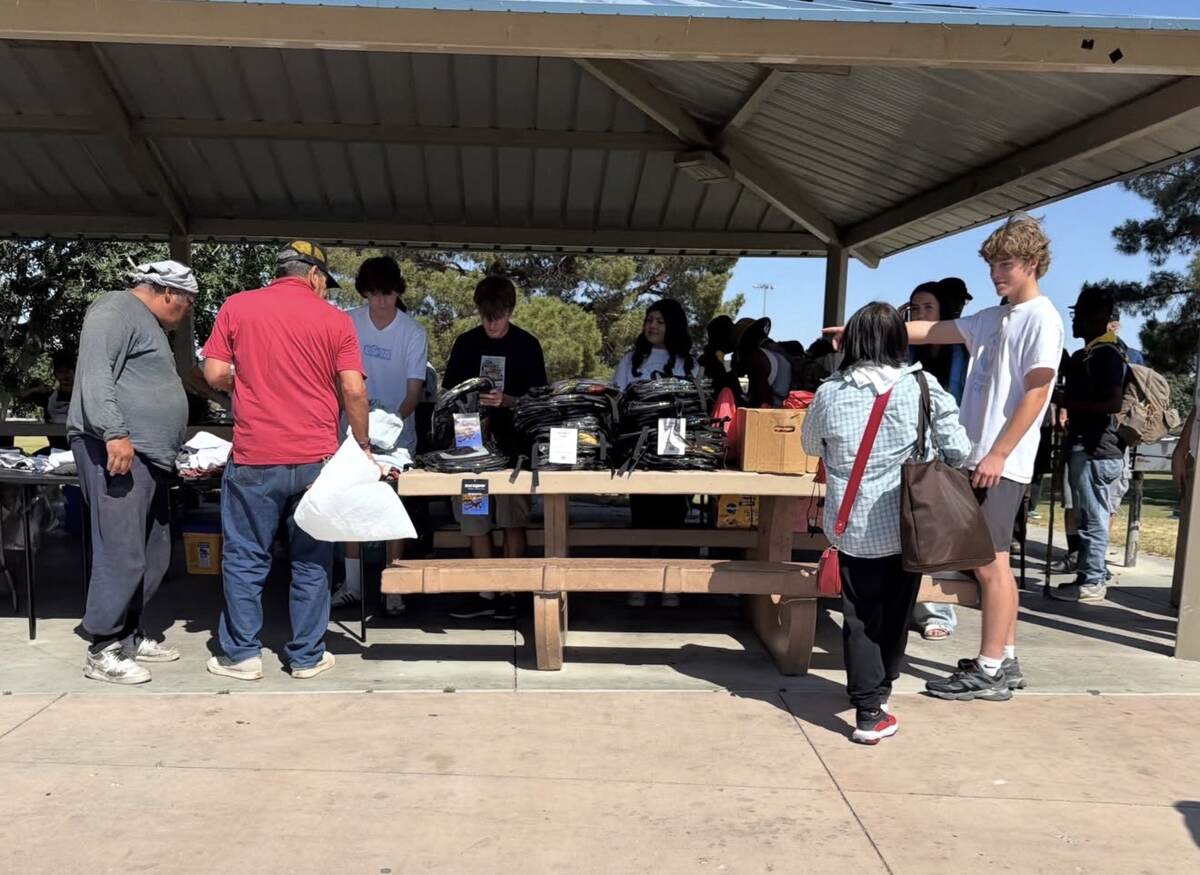 Youth volunteers distributing backpacks and supplies with 2ACT Ministries