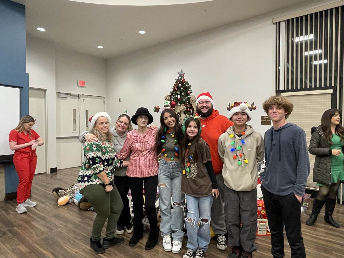 Volunteers gathered around the Christmas gift collection