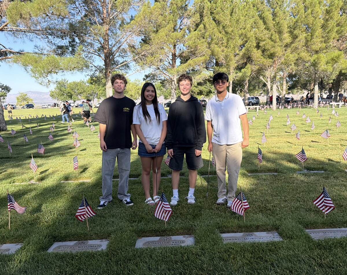 Creating a Giving Culture LV youth volunteers surrounded by flags at the Veterans Memorial