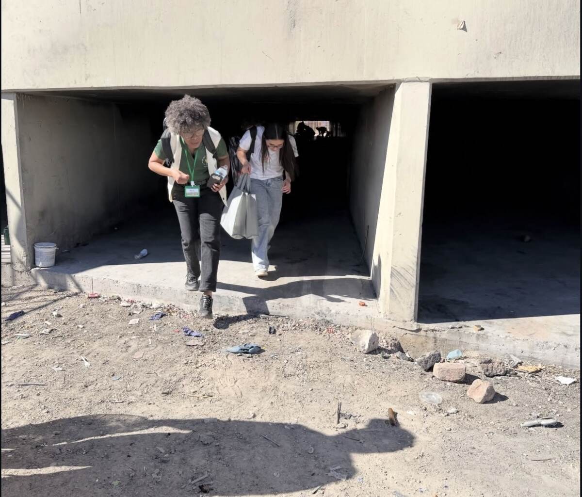 Outreach volunteers delivering bags beneath an overpass