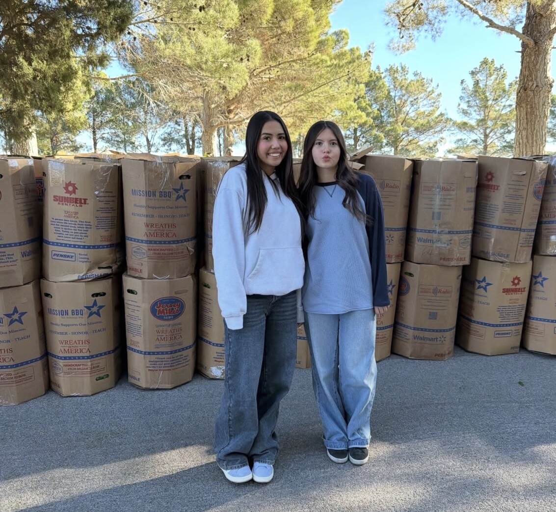 Aiyana and a youth volunteer standing with Wreaths Across America shipments ready for remembrance
